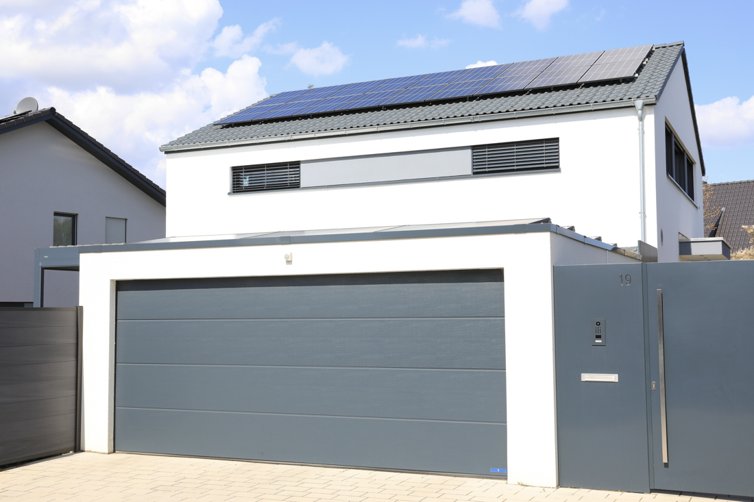 Modern wooden residential garage door in Toronto driveway