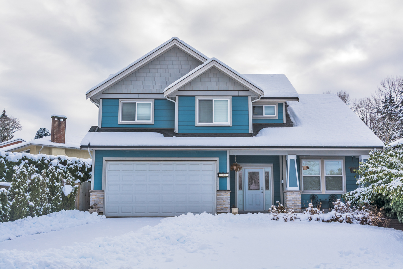 Modern white residential garage door installation in Canadian home