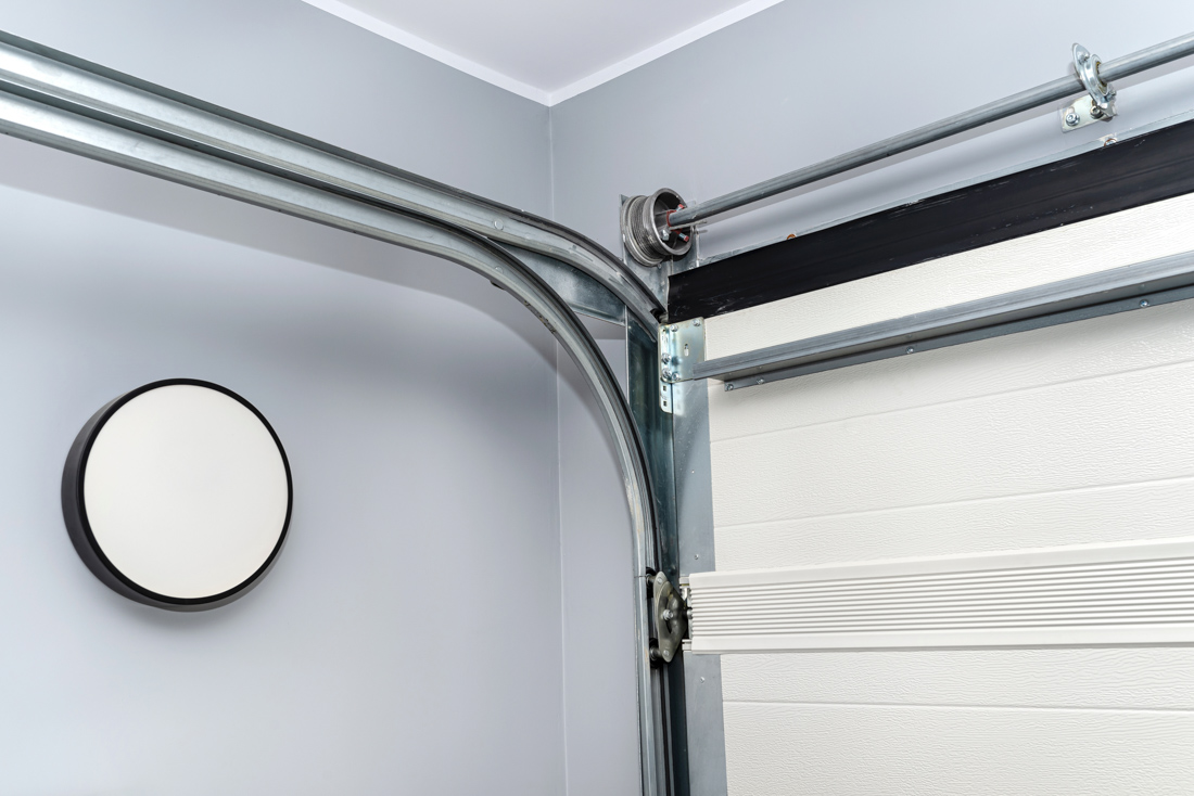 Modern residential garage doors with opener tracks installed