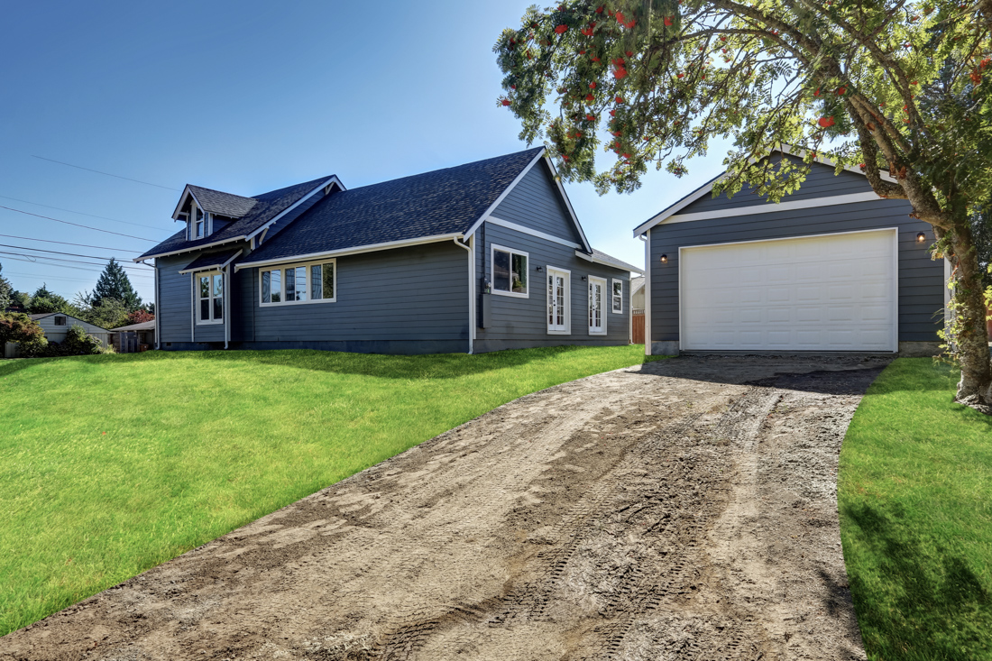White residential garage door on Canadian home driveway