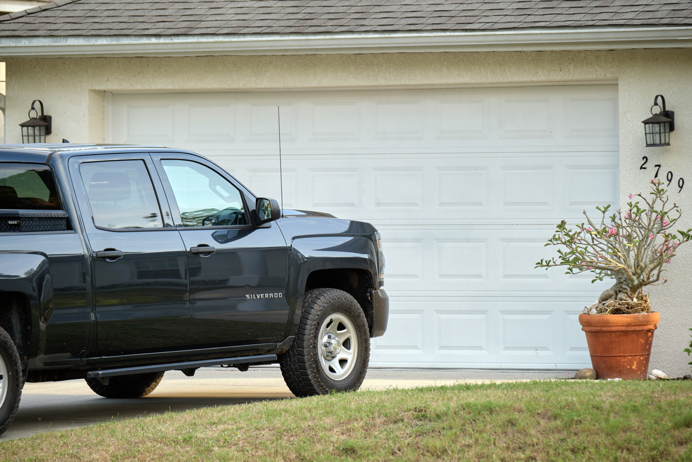 Residential garage door with parked pickup truck